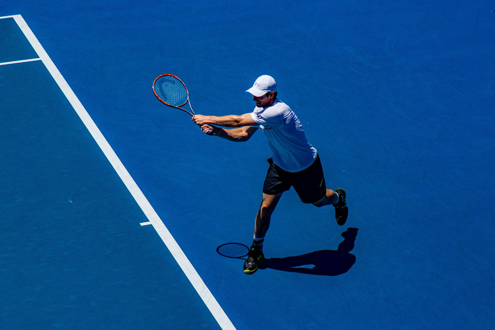 Active athlete playing tennis