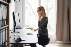 Woman working from home on an ergonomic set up